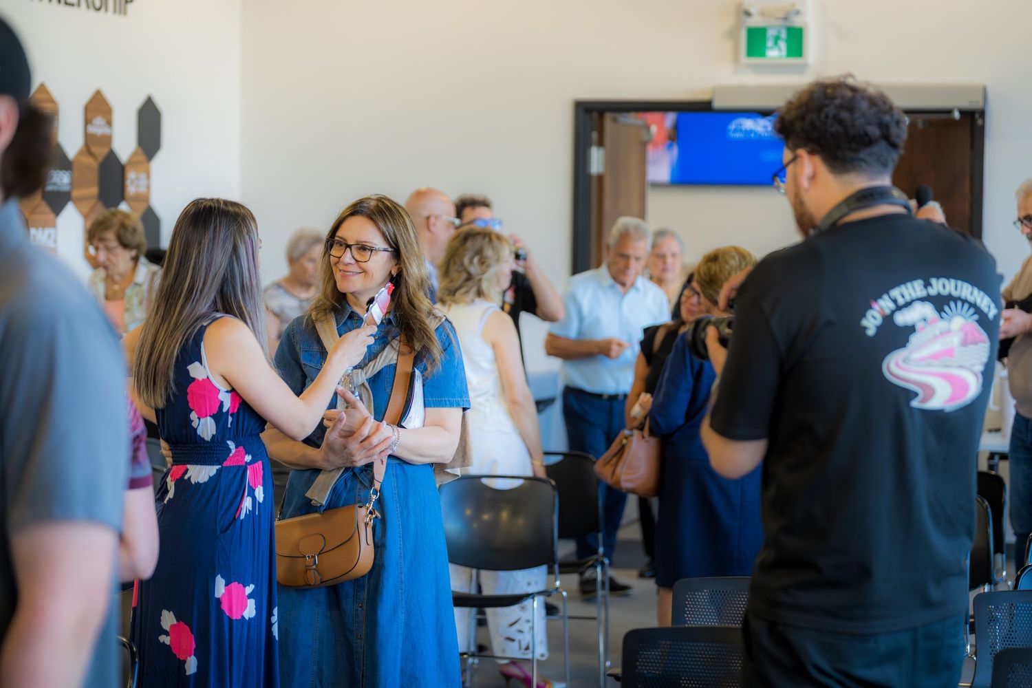 Guests mingle and socialize at indoor reception event for Neapolitan Ice Cream musical show.