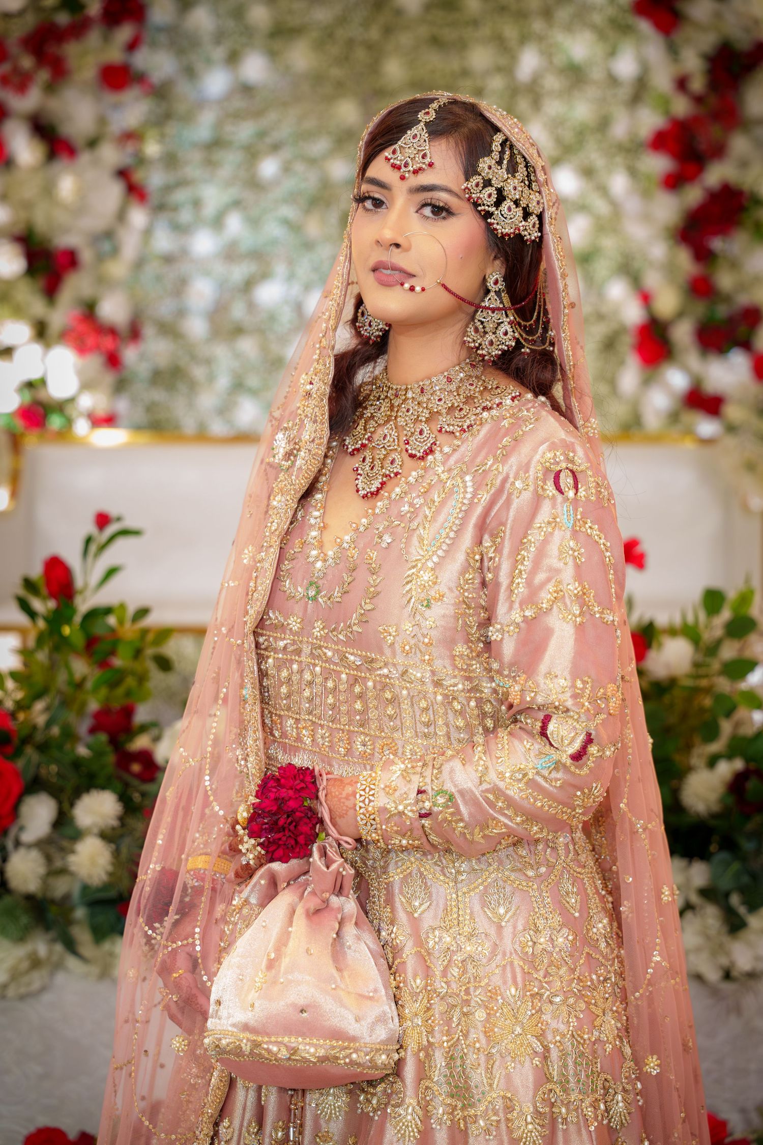Elegant bridal portraits featuring pink and gold embroidered wedding attire with intricate jewelry details.