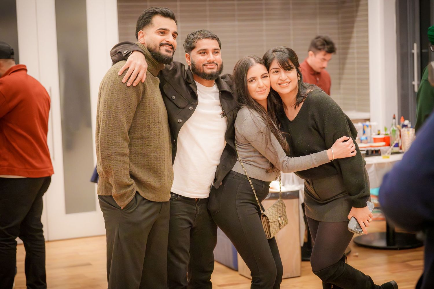 Friends posing together at an indoor party gathering.