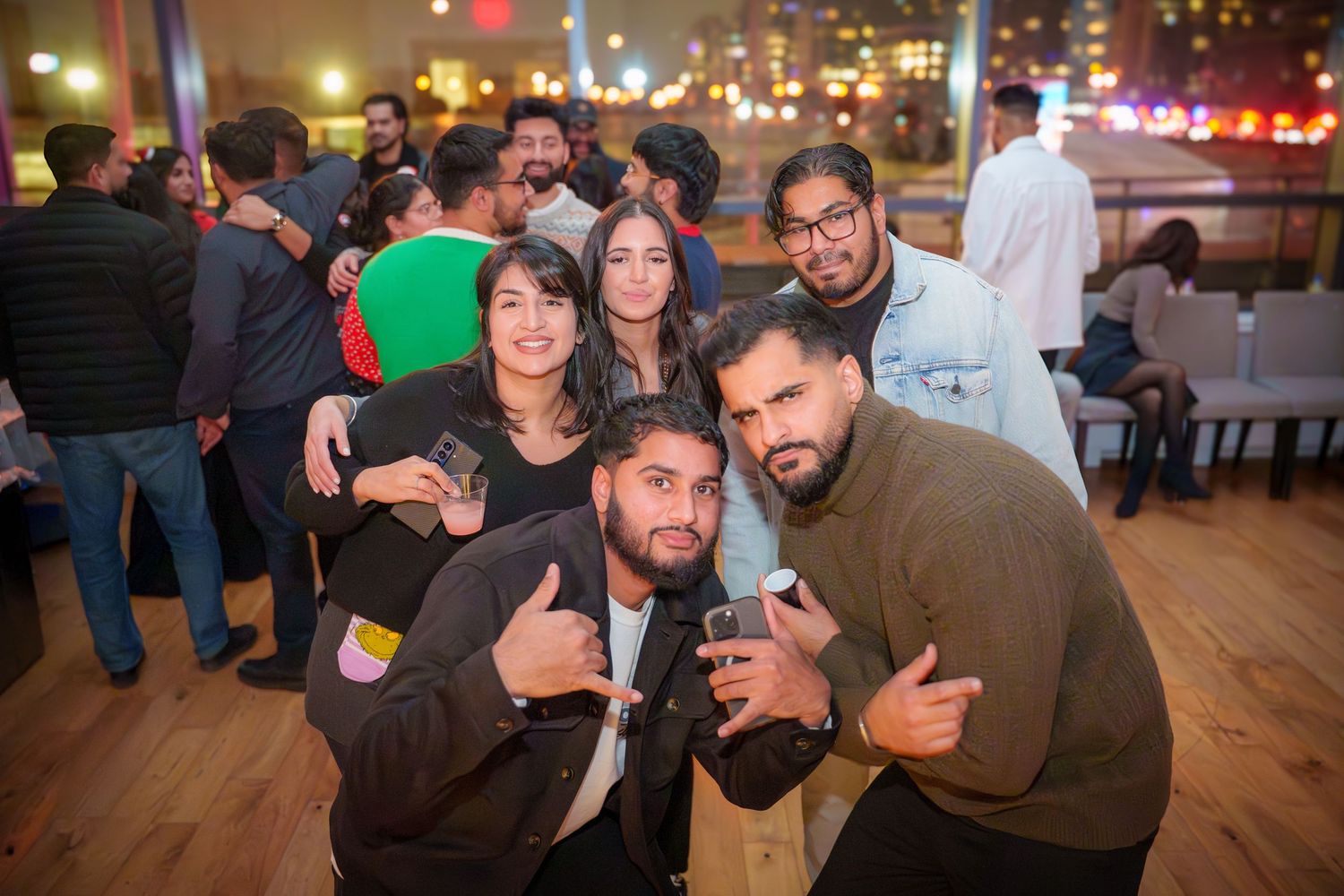 Party guests enjoying themselves at a lively indoor celebration.
