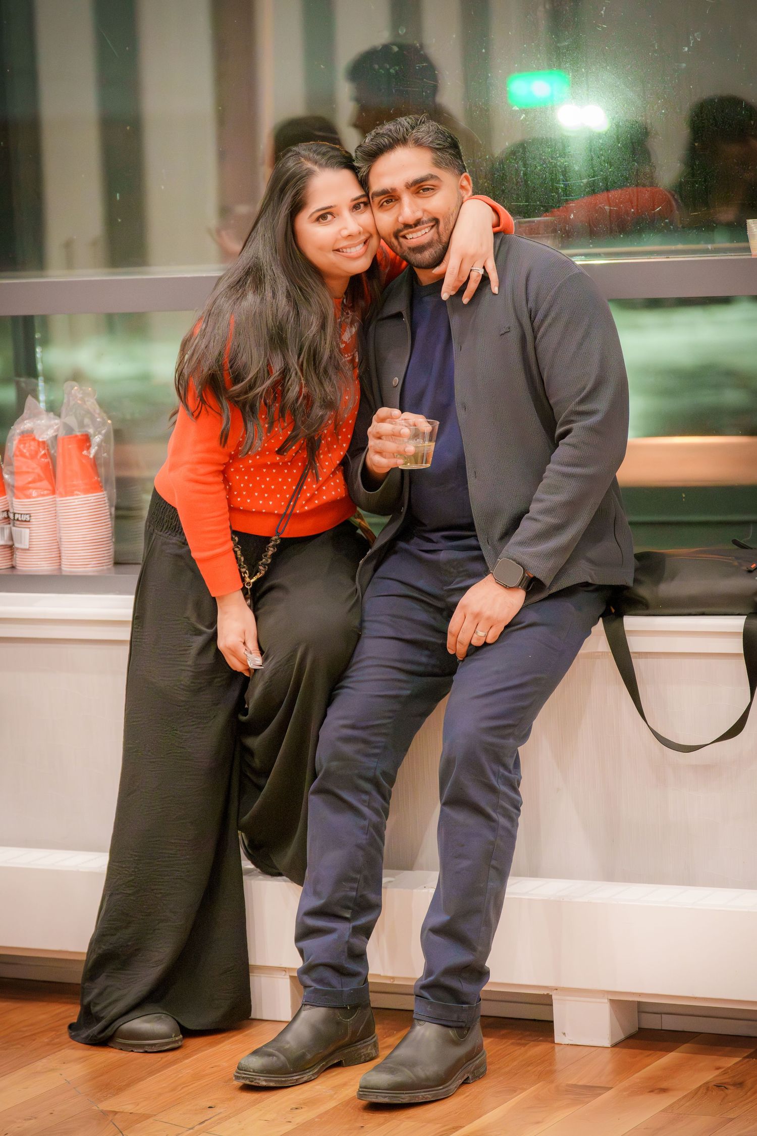 Candid moment of people laughing and enjoying themselves at an indoor party.