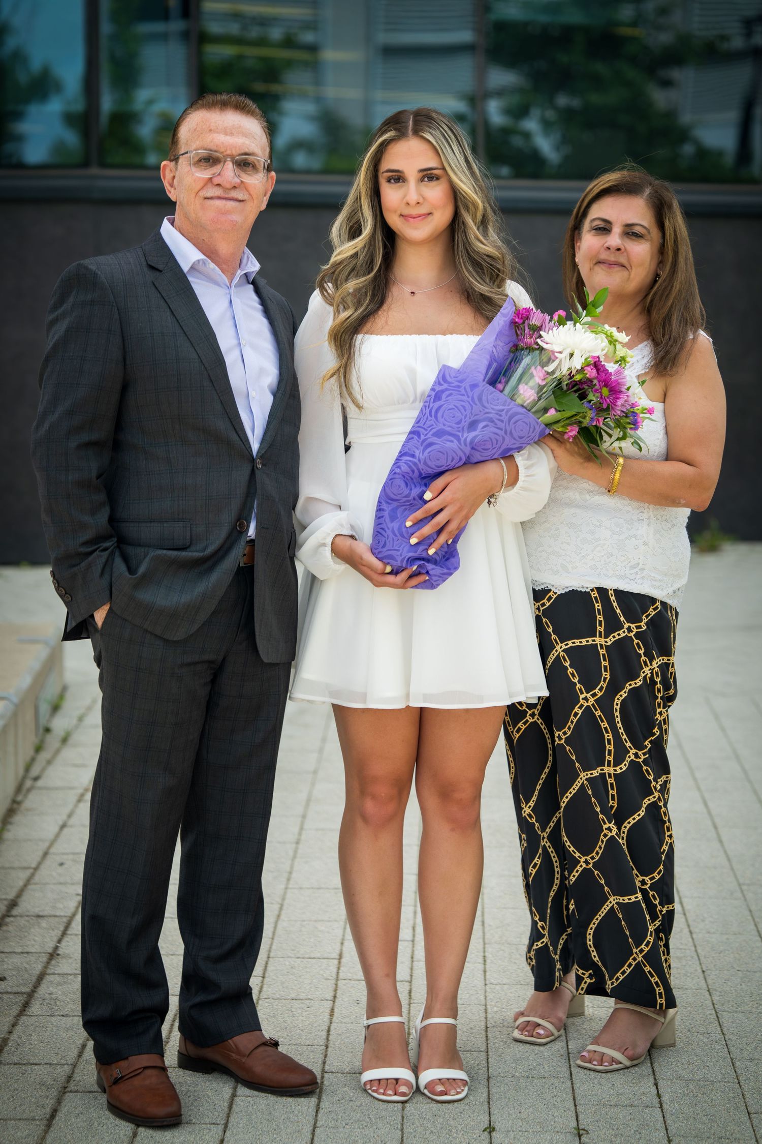 Group photo showing people in mix of formal and casual wear standing together.