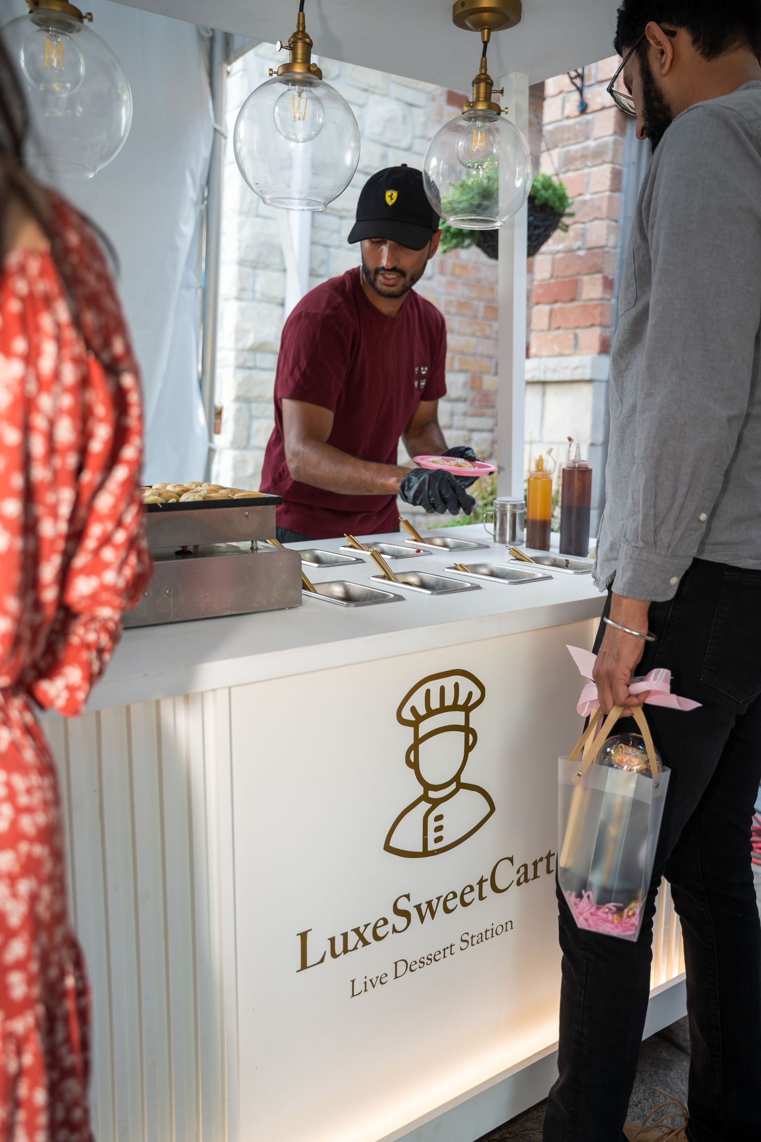 Luxe SweetCart dessert station setup with white counter and gold lettering.