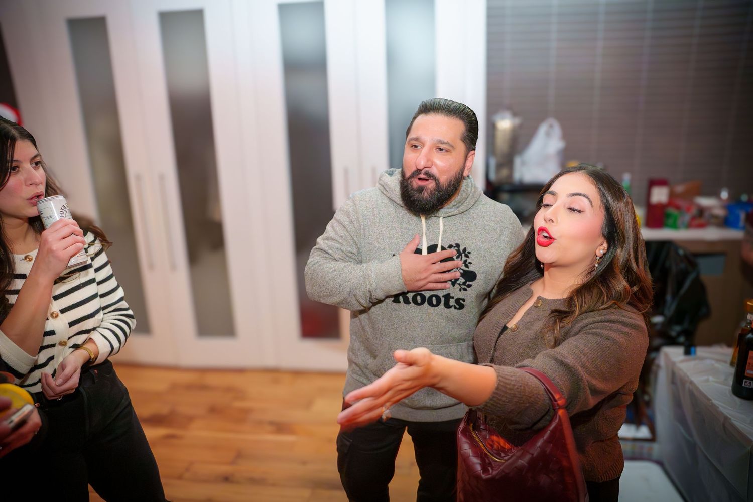 People having animated conversations during an indoor party.
