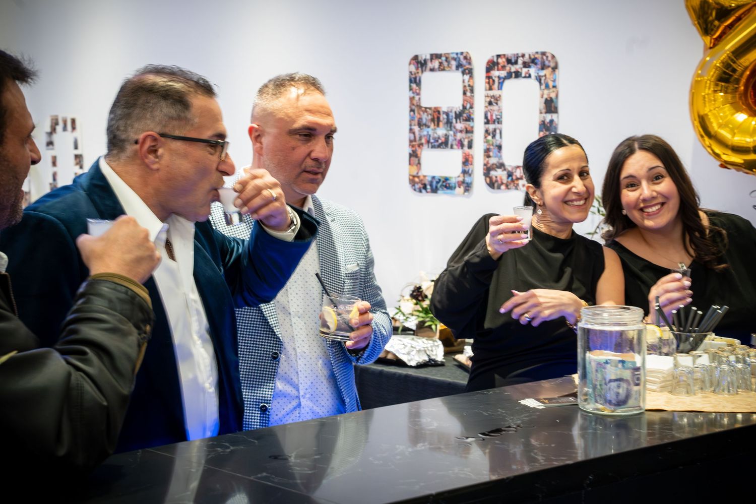 Guests enjoying drinks and conversation at an elegant business gathering.