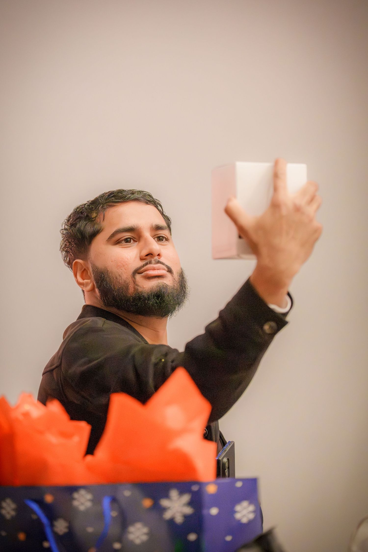 Person in dark clothing gesturing excitedly during a party game.