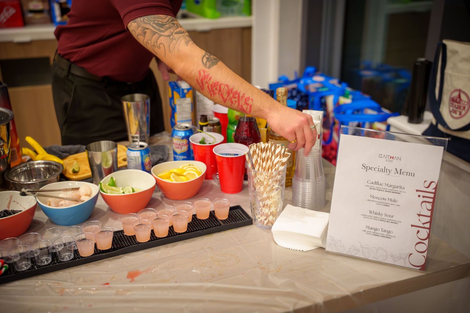 Party refreshment table with red cups and snacks laid out for guests.