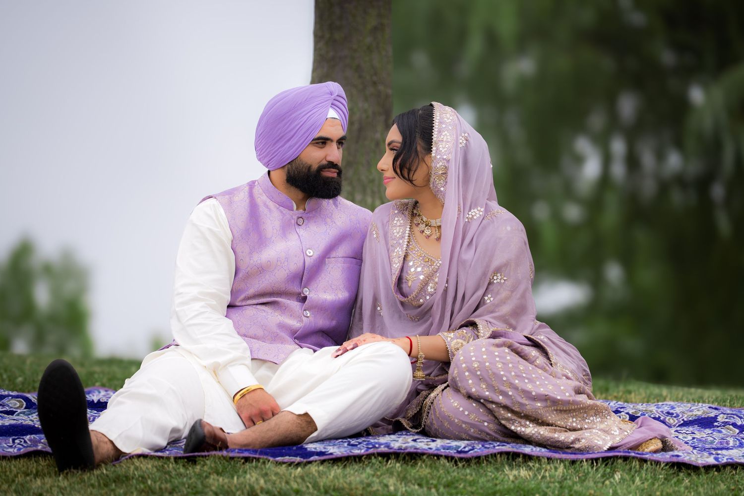 A romantic outdoor portrait session featuring a couple in coordinated purple and white attire.