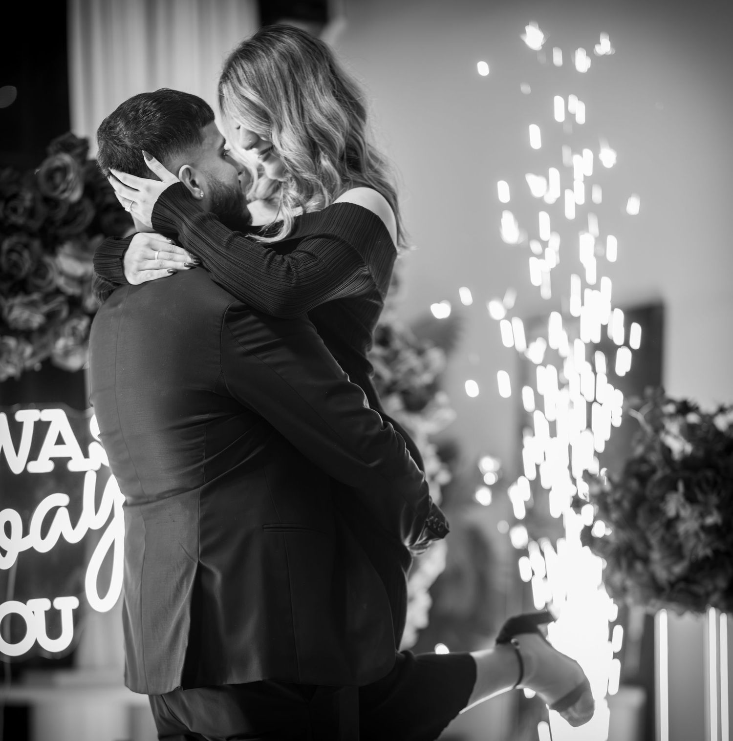 Black and white engagement photos with sparklers and neon lighting.