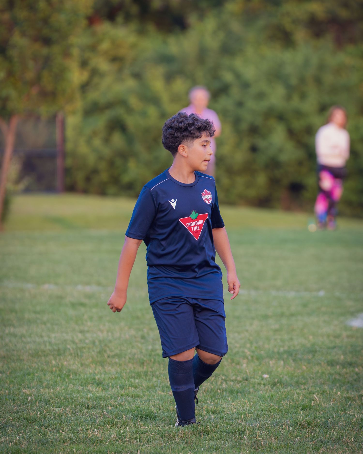 A sequence of five action shots shows a young soccer player practicing dribbling drills on a grassy field.
