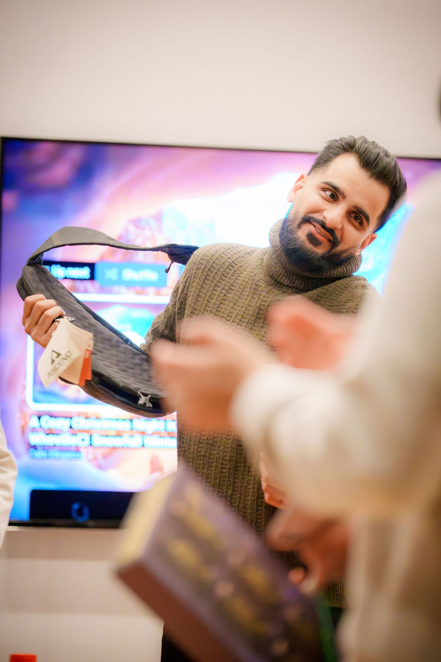 Person playing party games with TV screen visible in background.