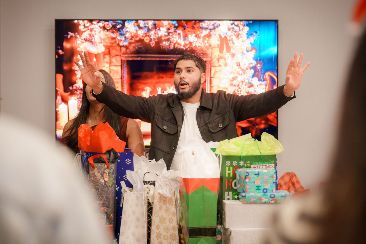 Large TV screen displaying colorful visuals during an indoor gathering.