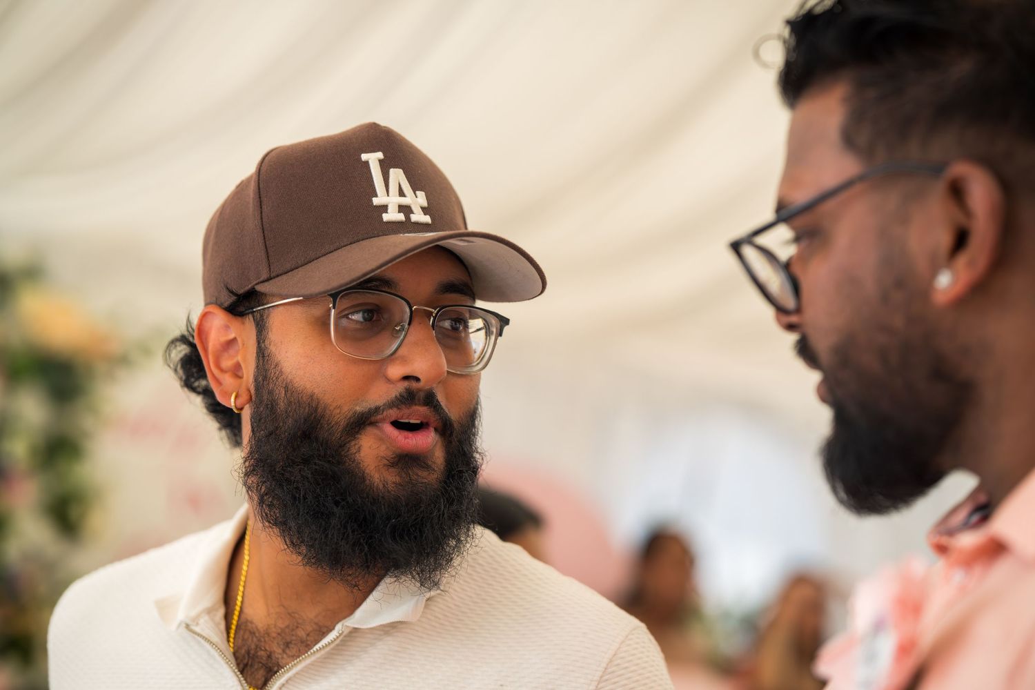 People in casual attire engaging in conversation at a social gathering.