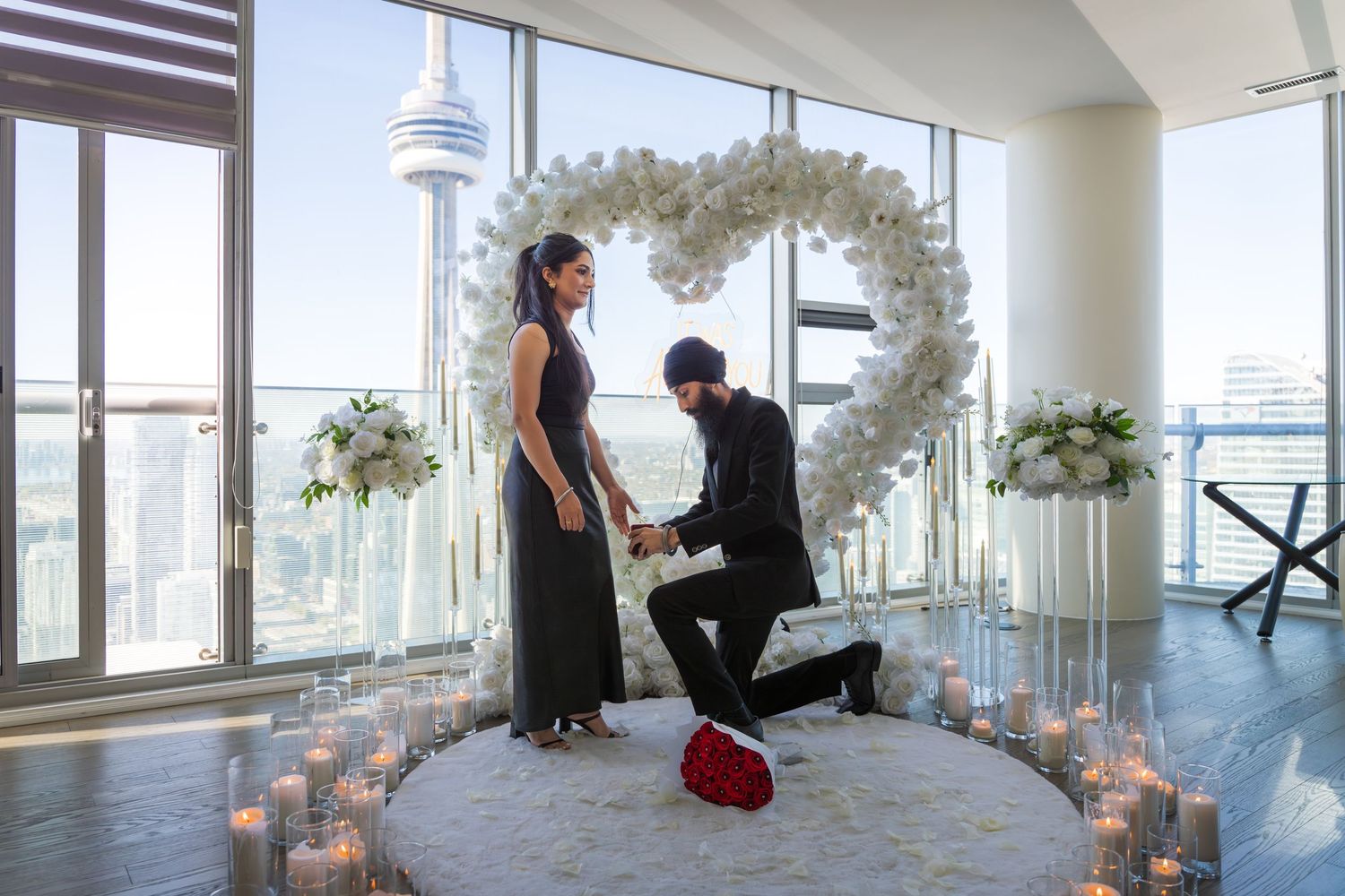 A modern yoga studio with floor-to-ceiling windows overlooking a cityscape features mats and meditation cushions.