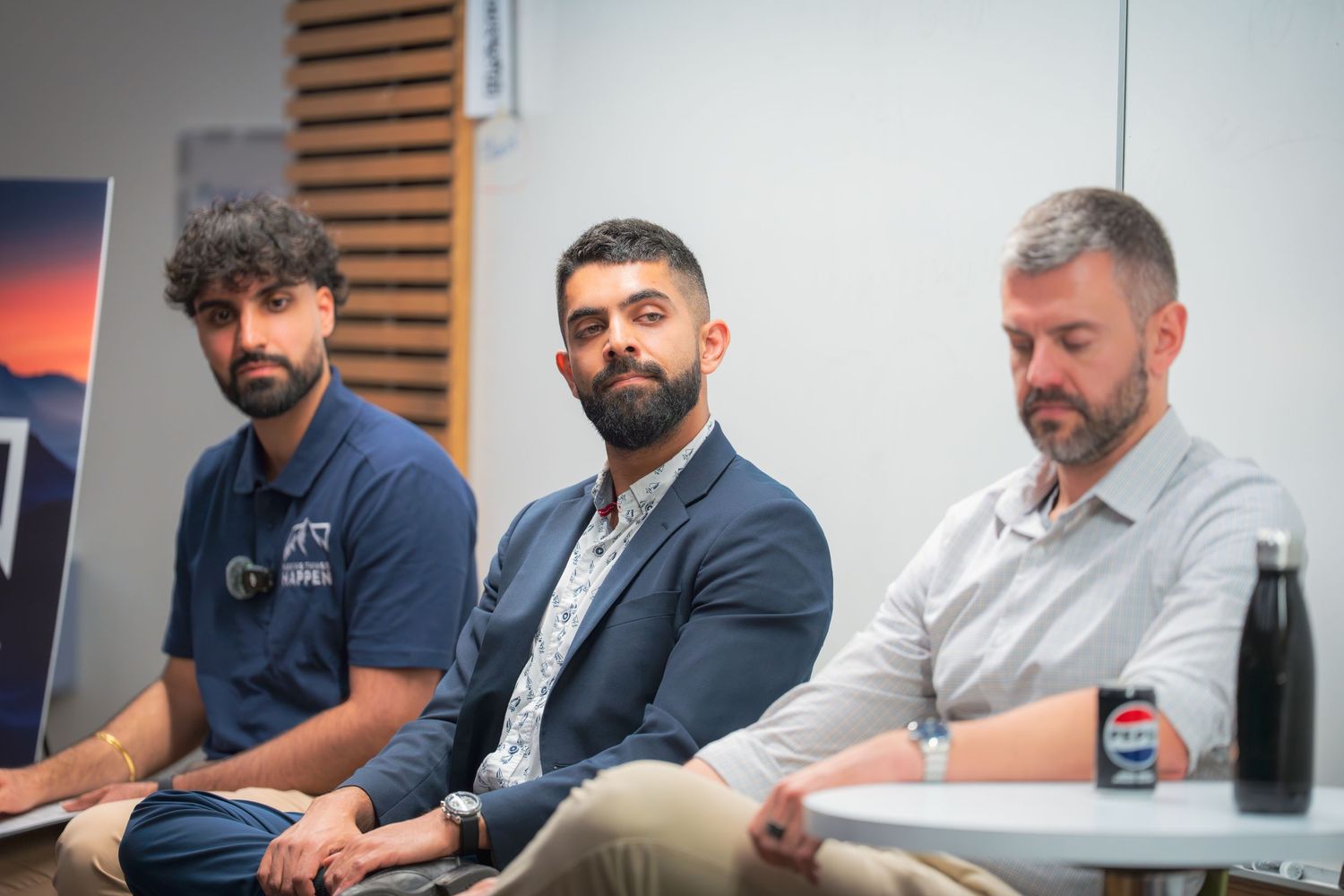 Professional panel discussion with speakers seated in business attire.
