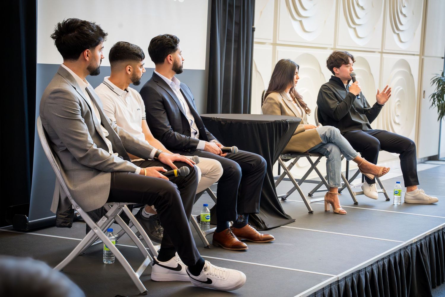 Panel discussion in progress with speakers seated on raised platform.