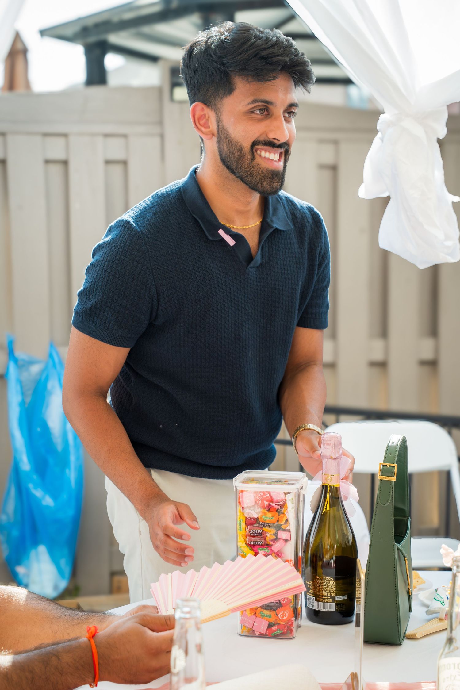 Guest enjoying refreshments at an outdoor celebration with white draping.
