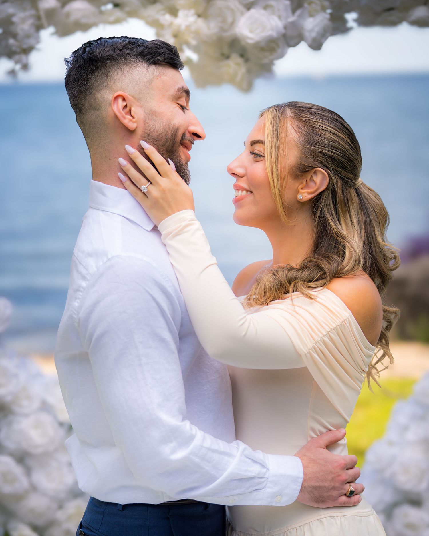 Romantic couple sharing an intimate moment against a blurred background.