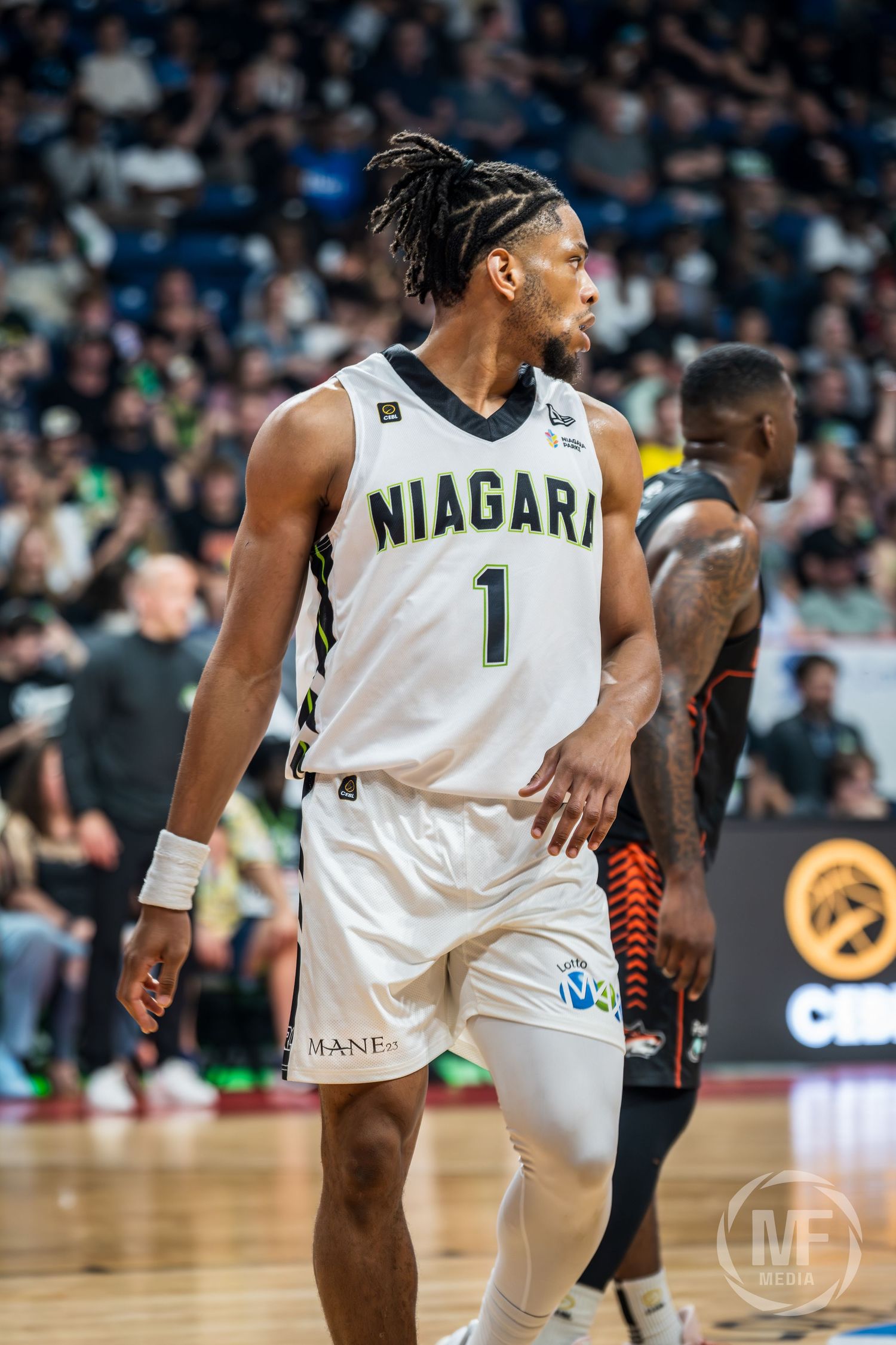 Niagara basketball player number 1 with braids walks on court during a professional CEBL game.