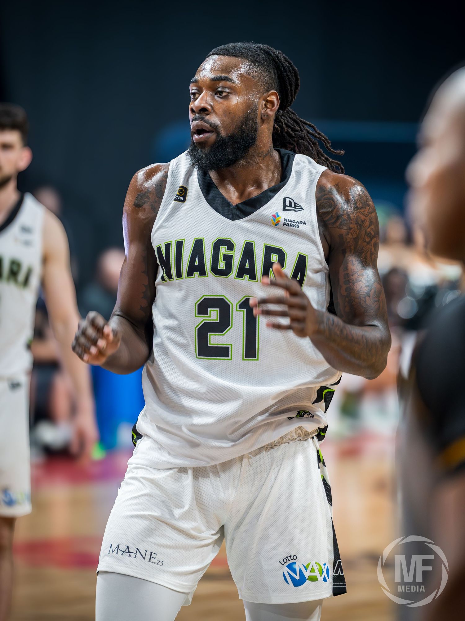 Niagara basketball player number 21 in white uniform during a professional game.