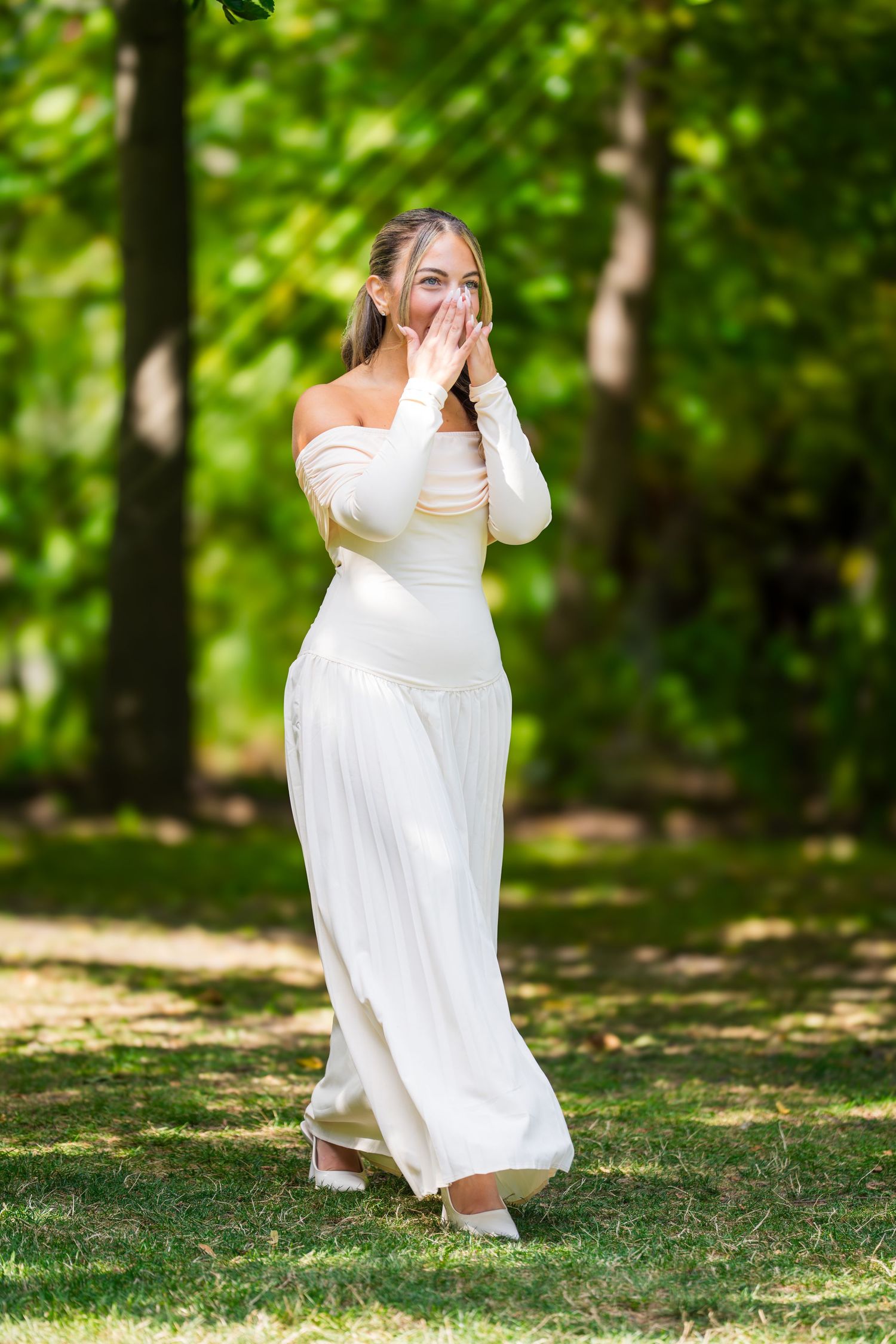 A graceful twirl of a white wedding dress in a sunlit garden setting.