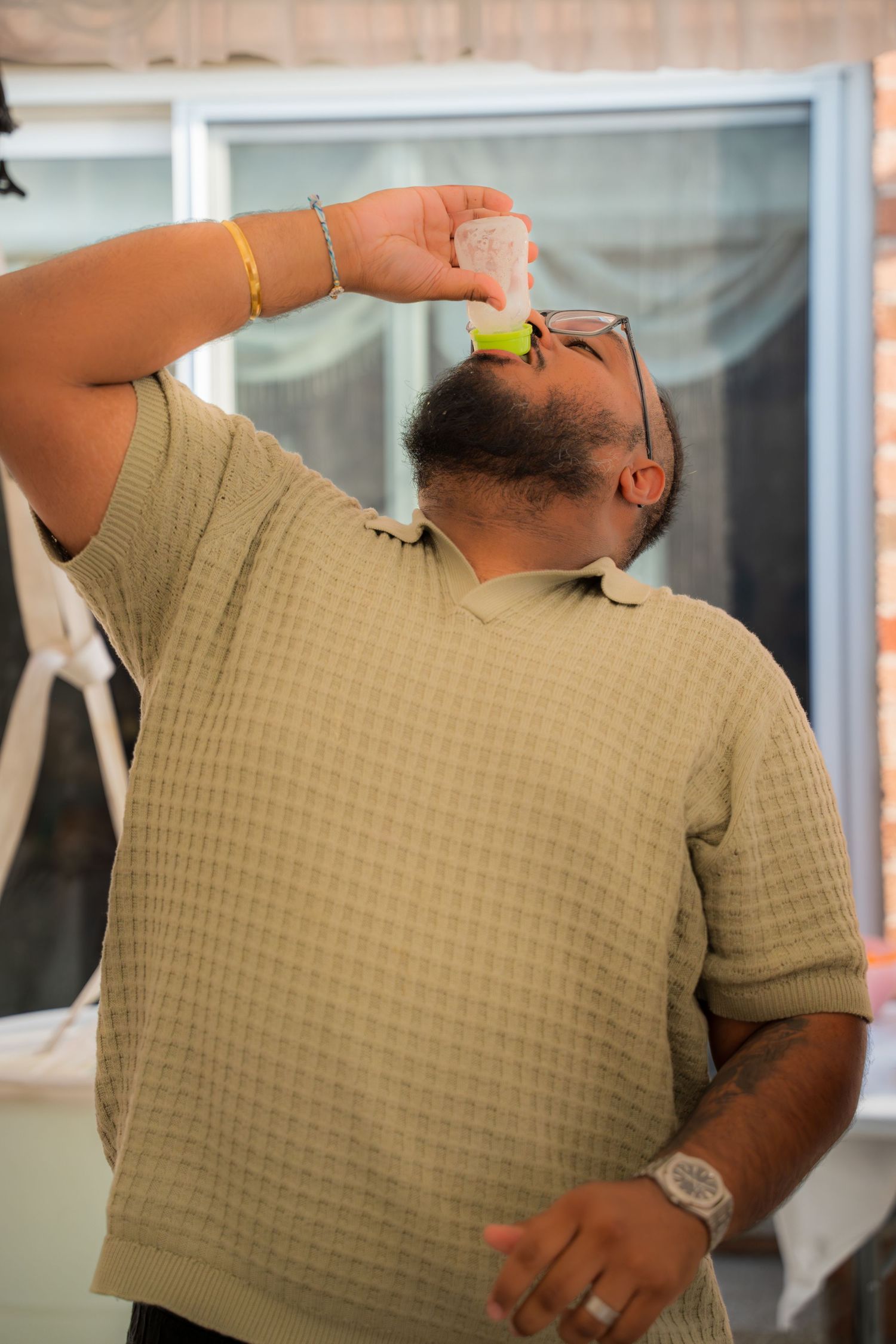 Person in tan checkered shirt drinking from a glass in sequence.