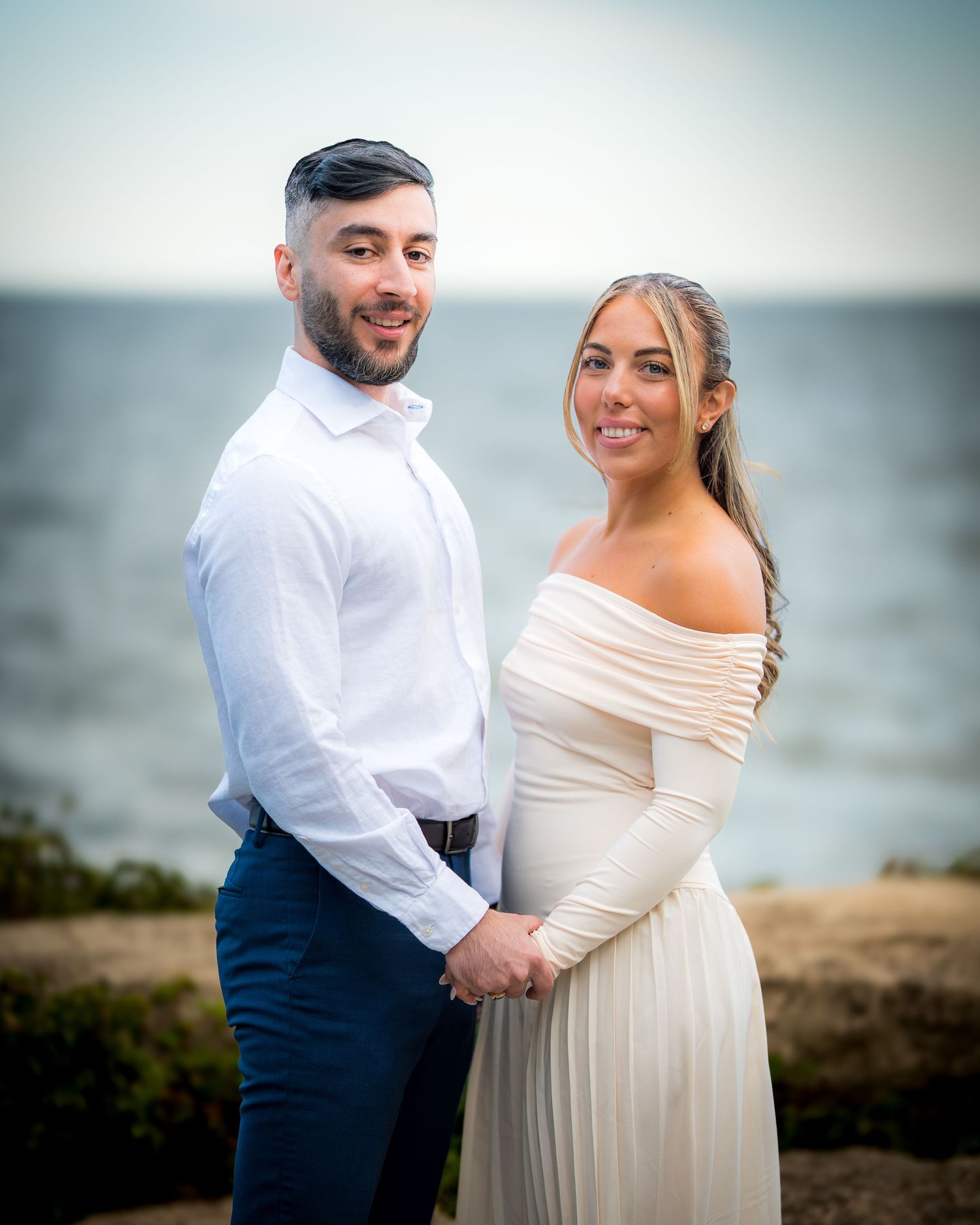 A couple laughs together during their coastal photo session.