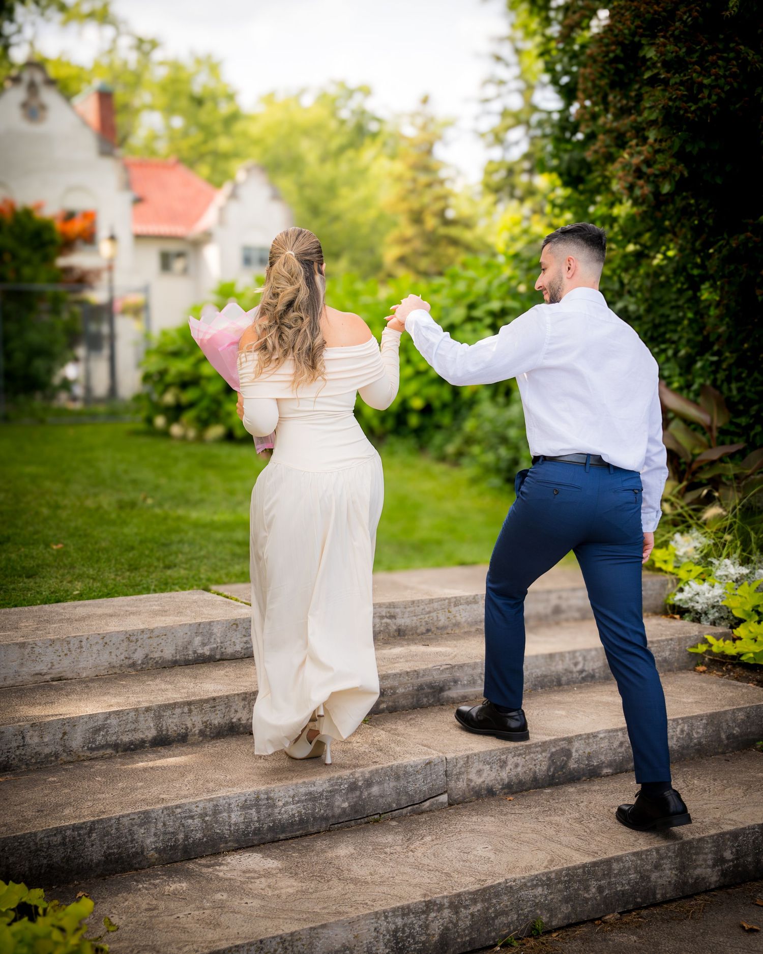 A joyful moment captured on stone steps during a romantic proposal.