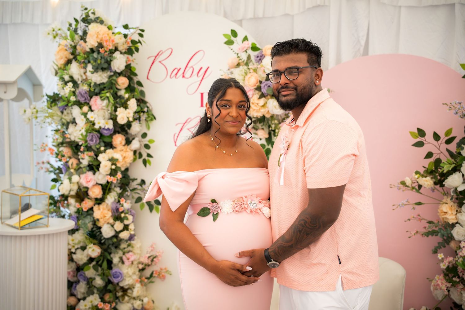 Beautiful baby shower decorations featuring pink theme and floral archway.