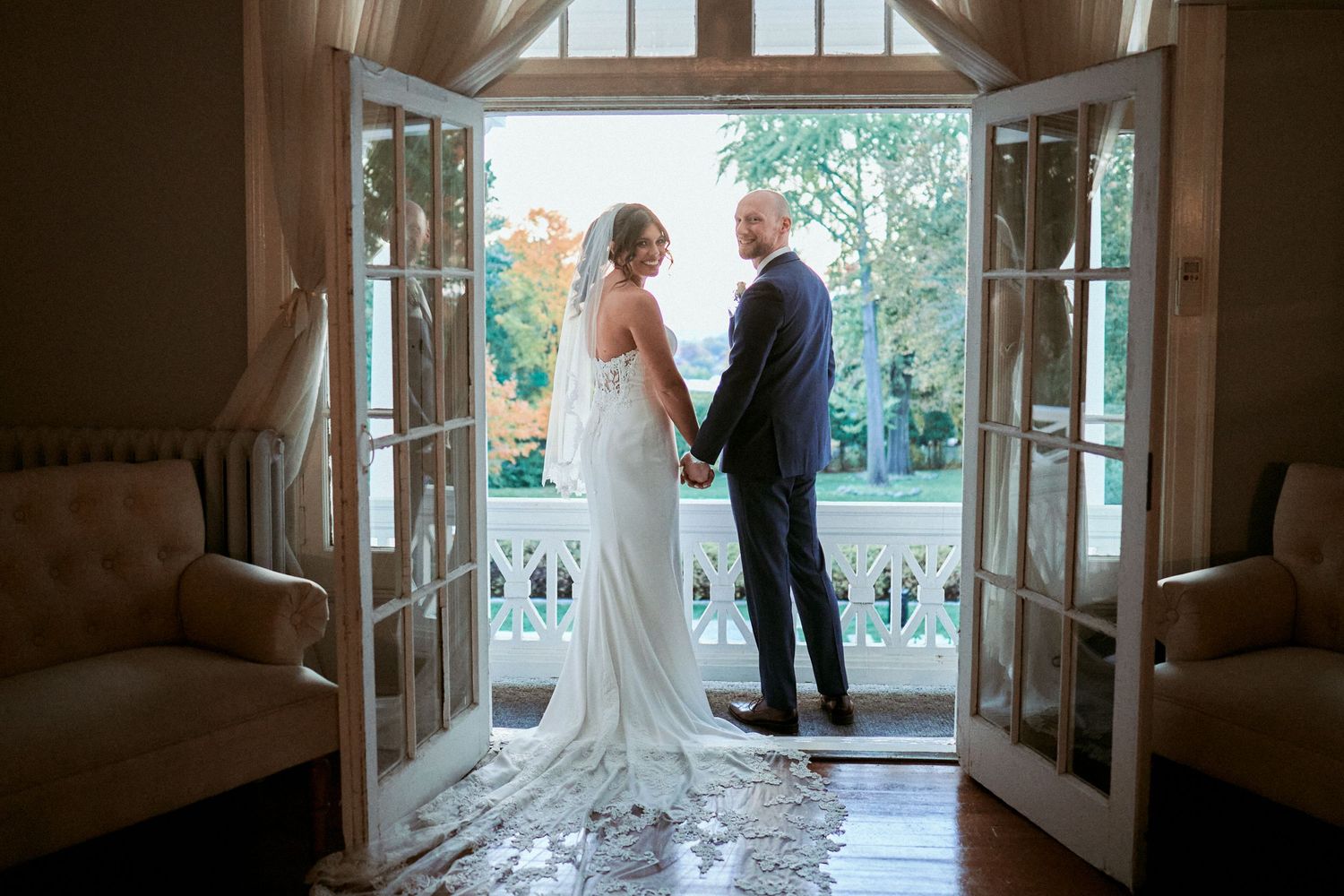 Nelstudios photographs a bride and groom at the Briarcliff Manor in Westchester, NY, where they candidly hold hands.