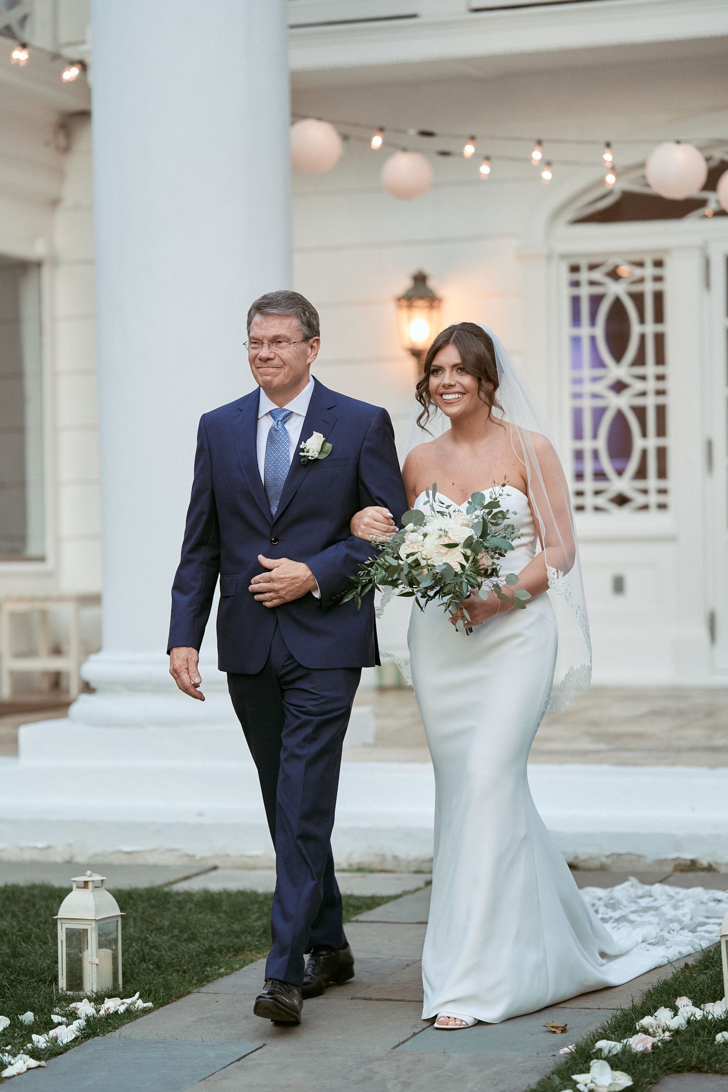 Nelstudios photographs a bride at the Briarcliff Manor in Westchester, NY, where the walks down the aisles with her dad in a natural moment.