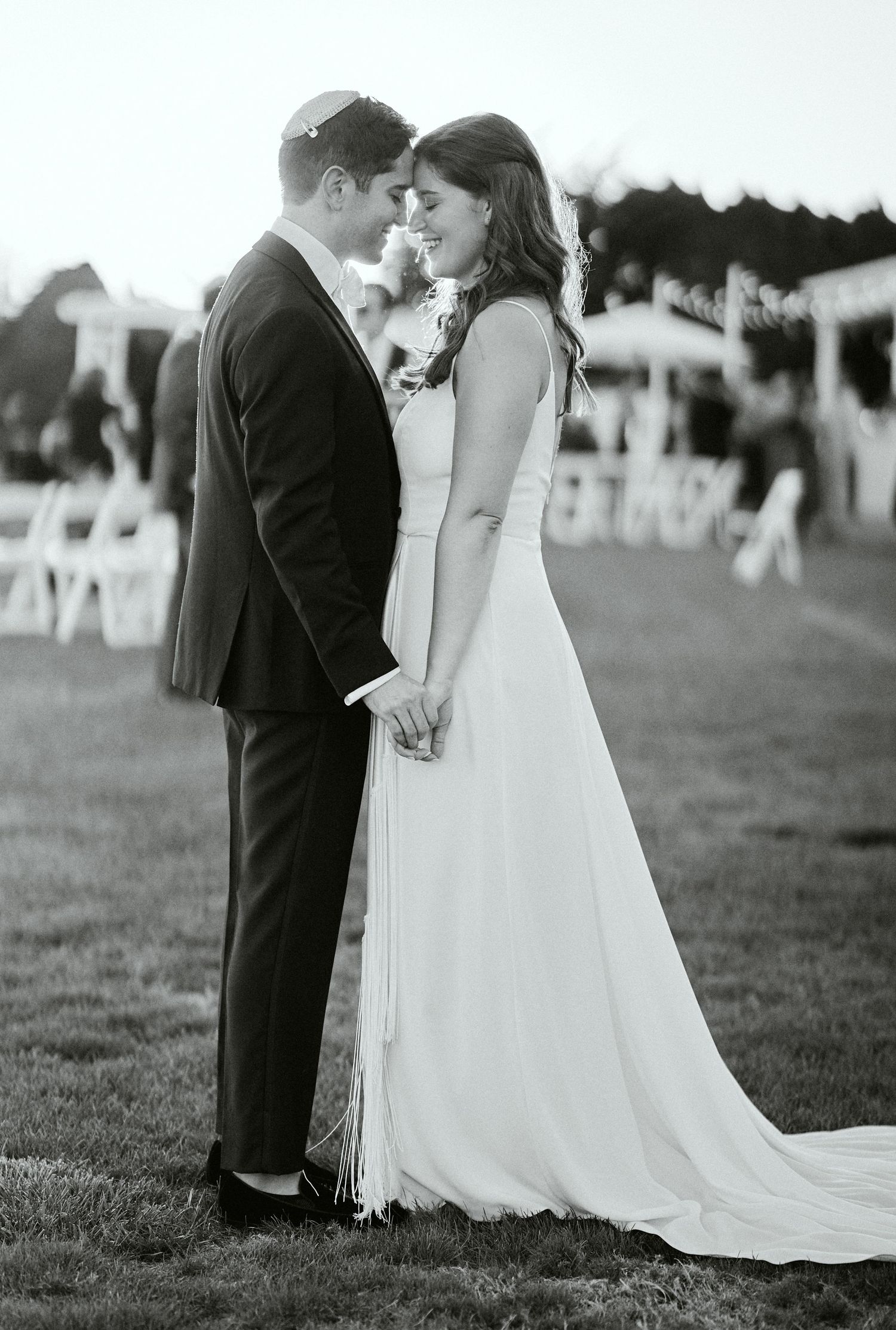 Nelstudios photographs a Jewish Wedding at The Inn at Longshore, Connecticut, where the bride shares a candid moment with the groom.