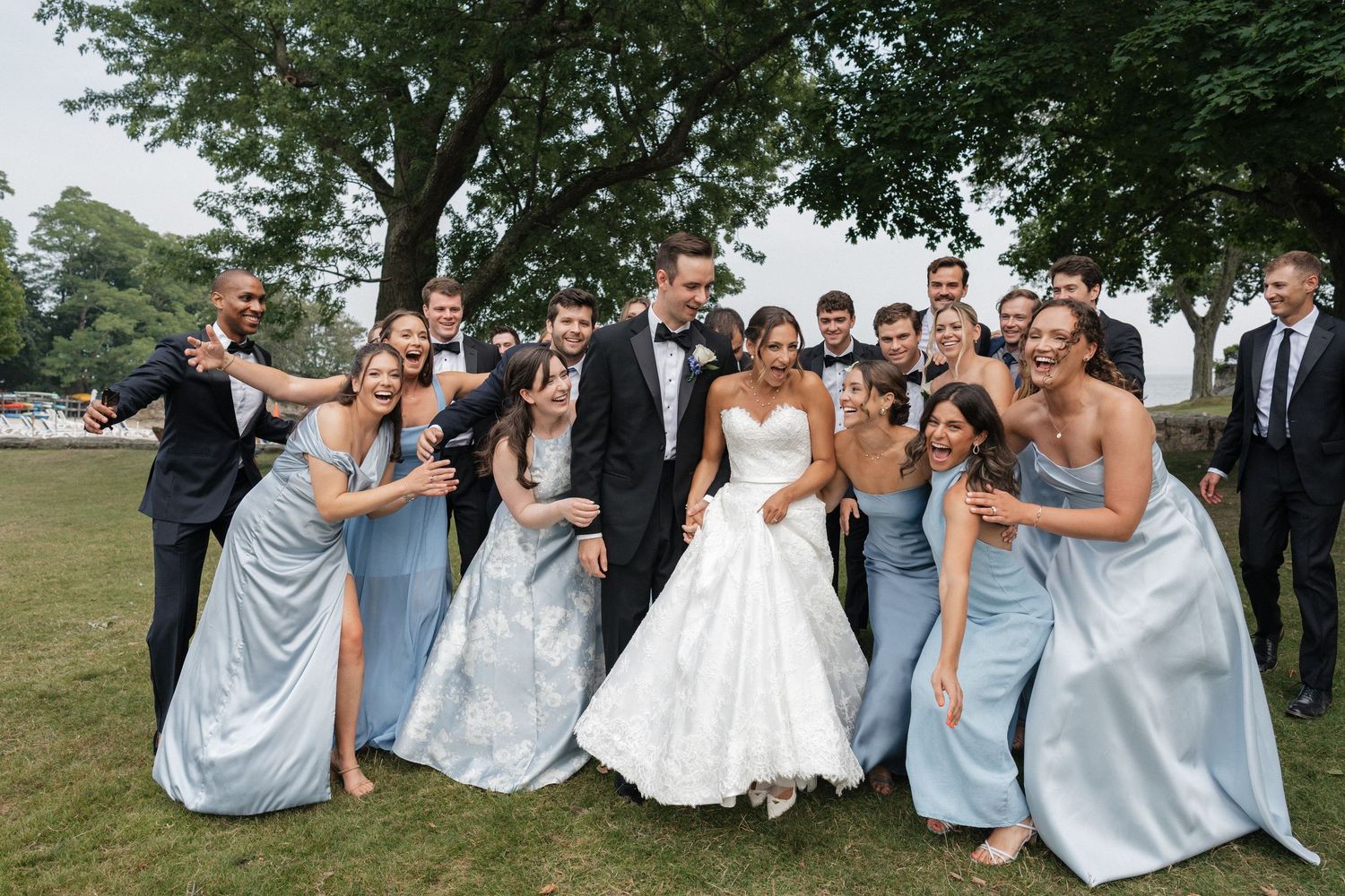 Nelstudios captures a natural, candid moment of the bride and groom having fun with bridesmaids at Whitby Castle, Rye, Westchester, NY.