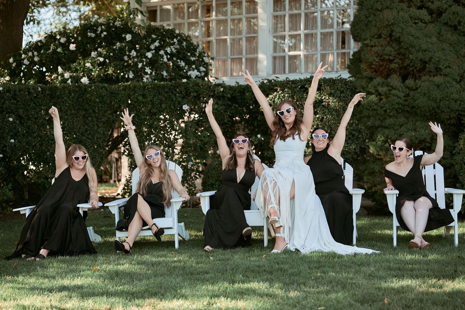 Nelstudios photographs a Jewish Wedding at The Inn at Longshore, Connecticut, USA where the bridesmaids all cheer in celebration.