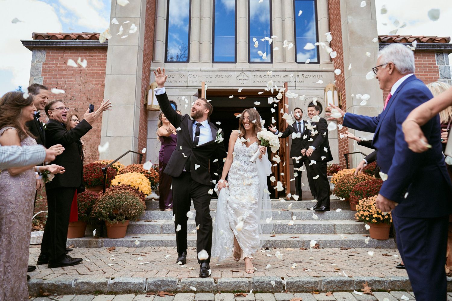 Nelstudios photographs a bride and groom in Westchester, NY, where they walk out of the church together after their wedding ceremony.