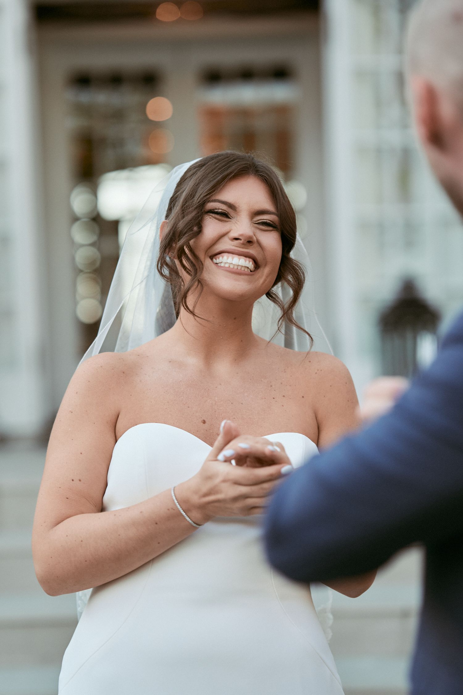 Nelstudios photographs a bride's candid and natural smile at the Briarcliff Manor in Westchester, NY, where she looks at her new husband.