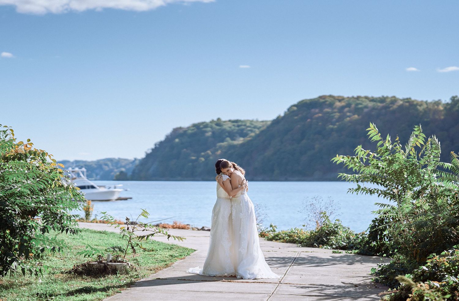 Nelstudios photographs two brides at The Grandview in Poughkeepsie, NY, where the brides candidly hug during an LGBTQ wedding.