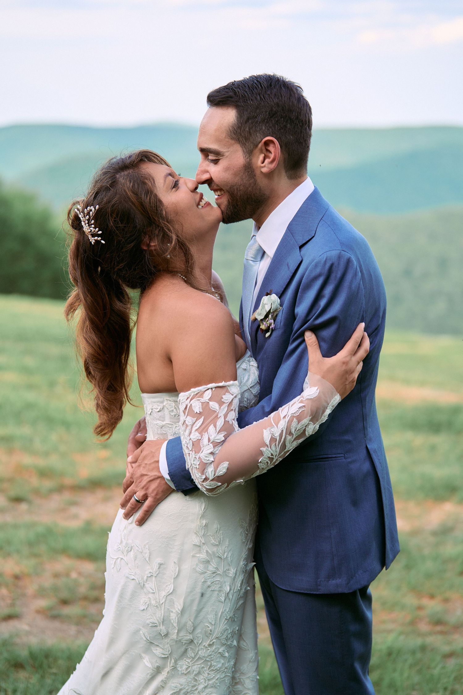Nelstudios photographs a candid moment of a bride and groom holding each other at the top of Plattekill Mountain in Hudson-Valley, NY.
