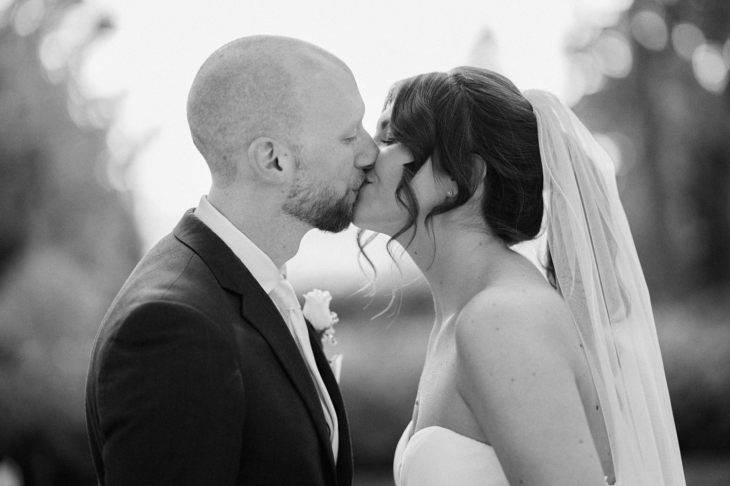 Nelstudios photographs a bride and groom at the Briarcliff Manor in Westchester, NY, where they take their first kiss during the wedding.