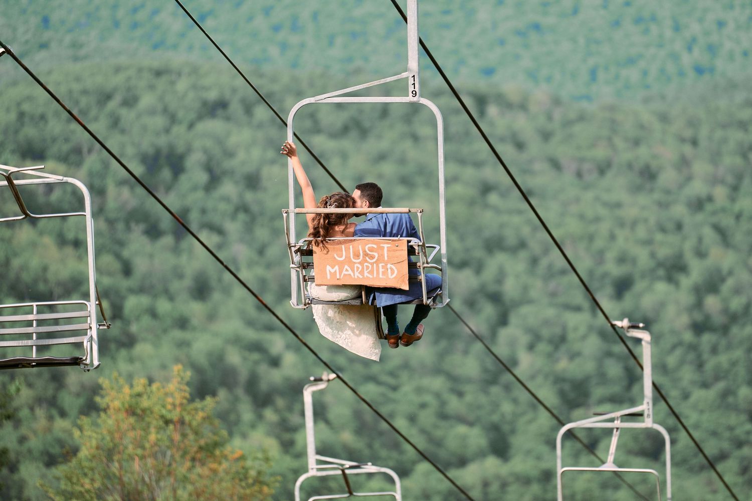 Nelstudios photographs a real moment of a bride and groom making their way down from the top of Plattekill Mountain in Hudson-Valley, NY.