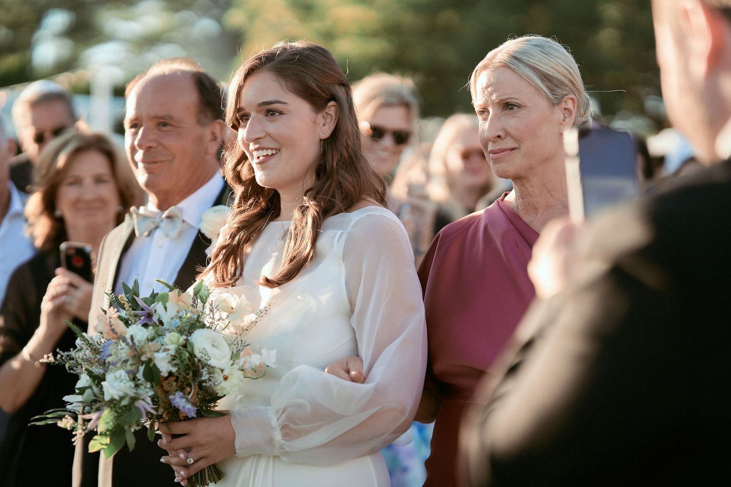 Nelstudios photographs a Jewish Wedding at The Inn at Longshore, Connecticut, where the brides walks down the aisle with her mom and dad.