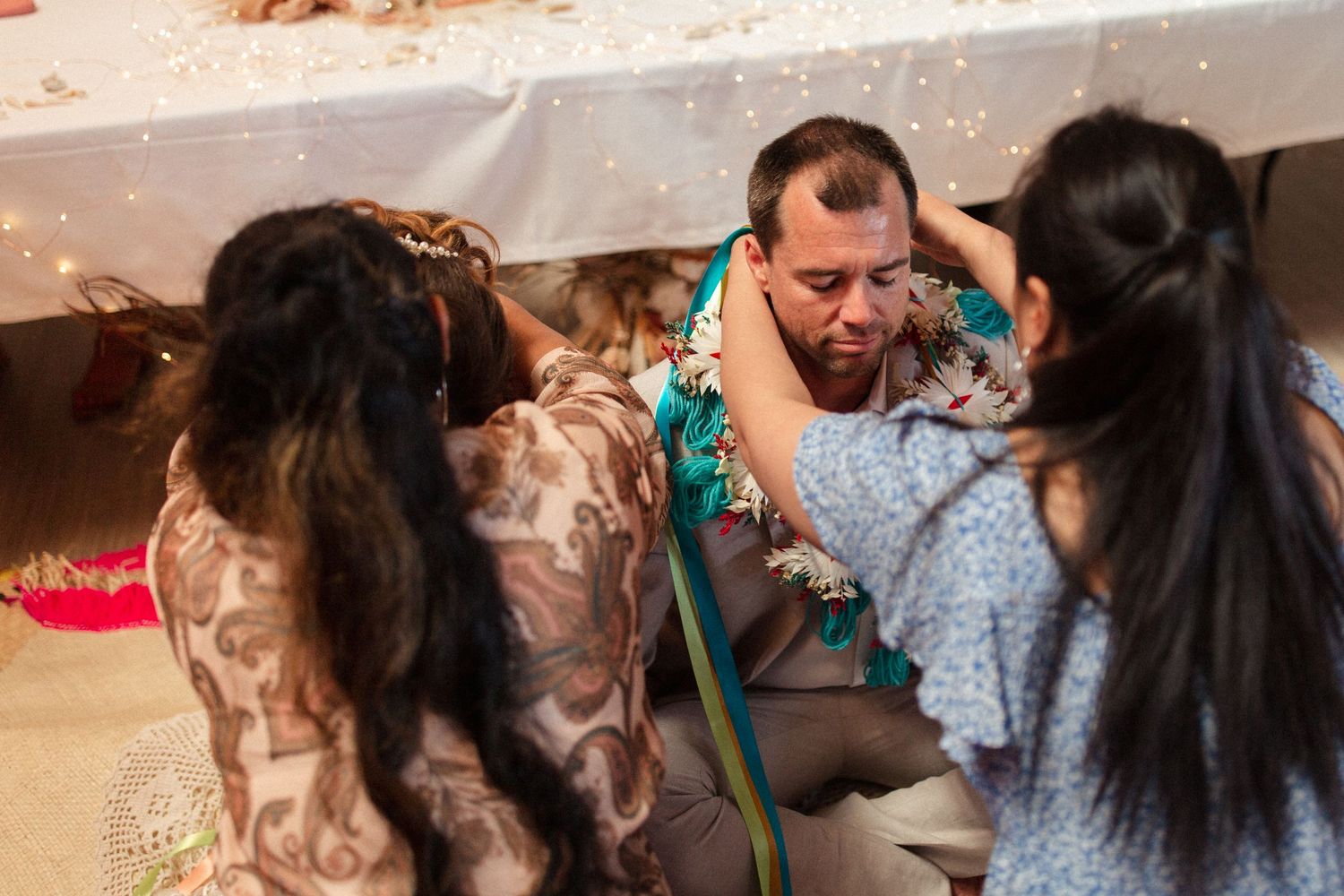 Wedding guests gather around during a festive reception celebration moment.