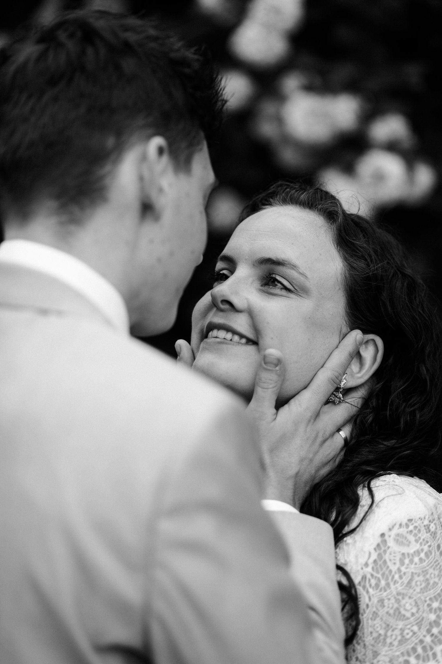 Black and white intimate wedding moment showing gentle affection.