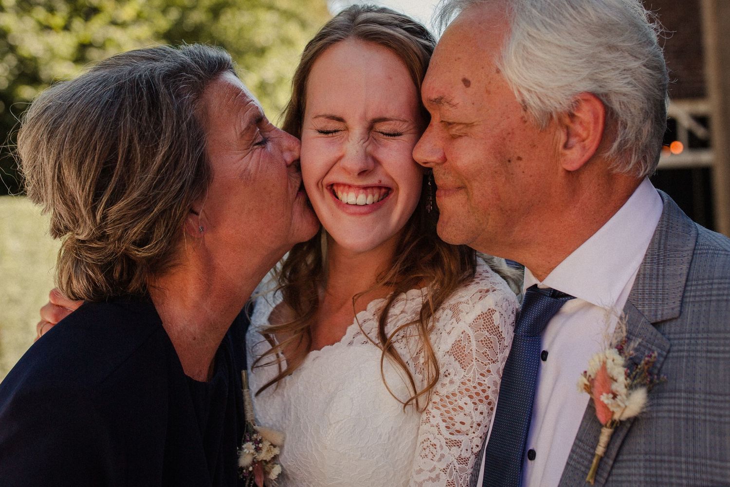 A joyful moment captured during a wedding celebration outdoors on a sunny day.