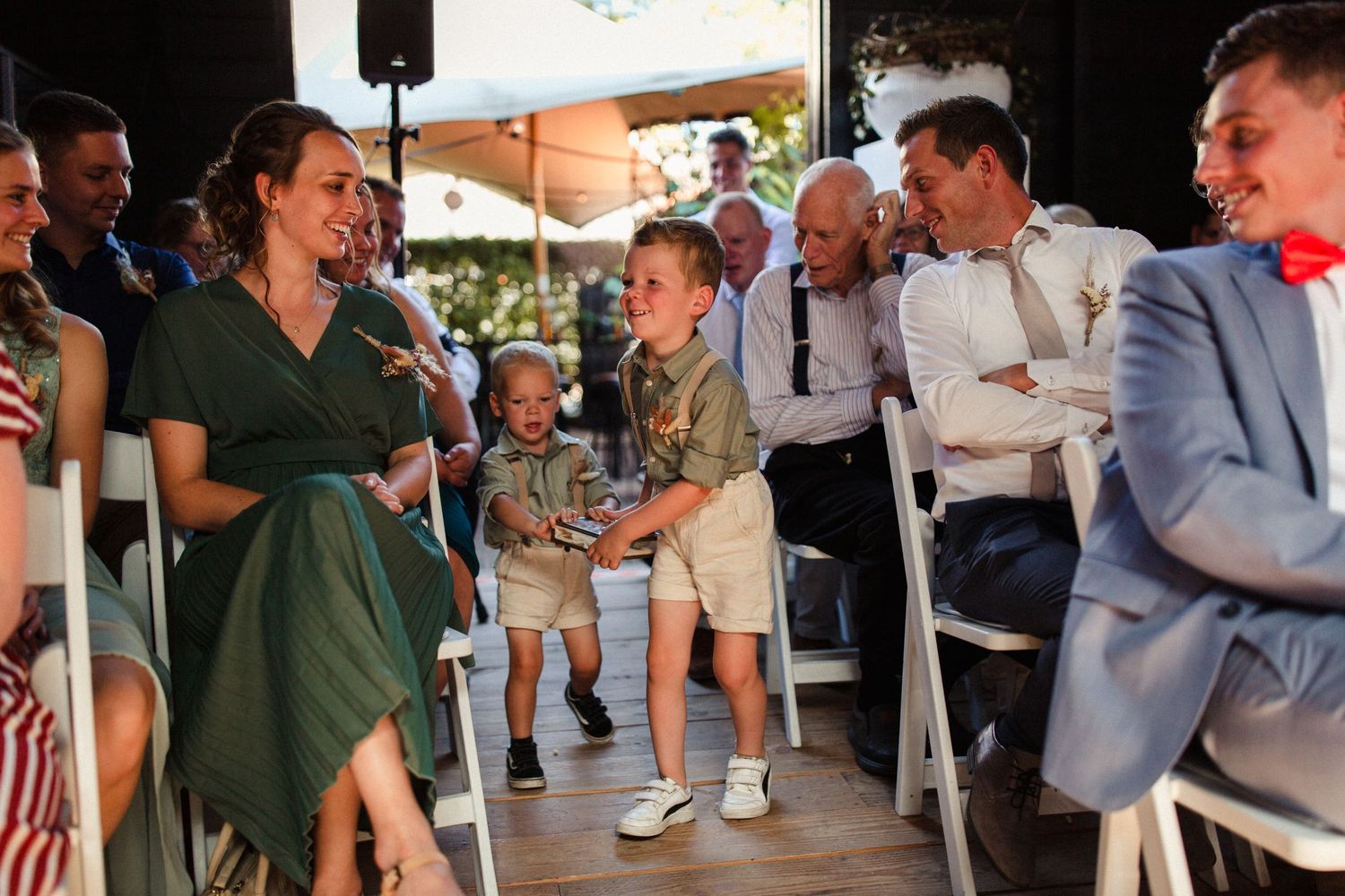 People dancing and enjoying themselves at an outdoor party venue with a wooden deck and casual atmosphere.