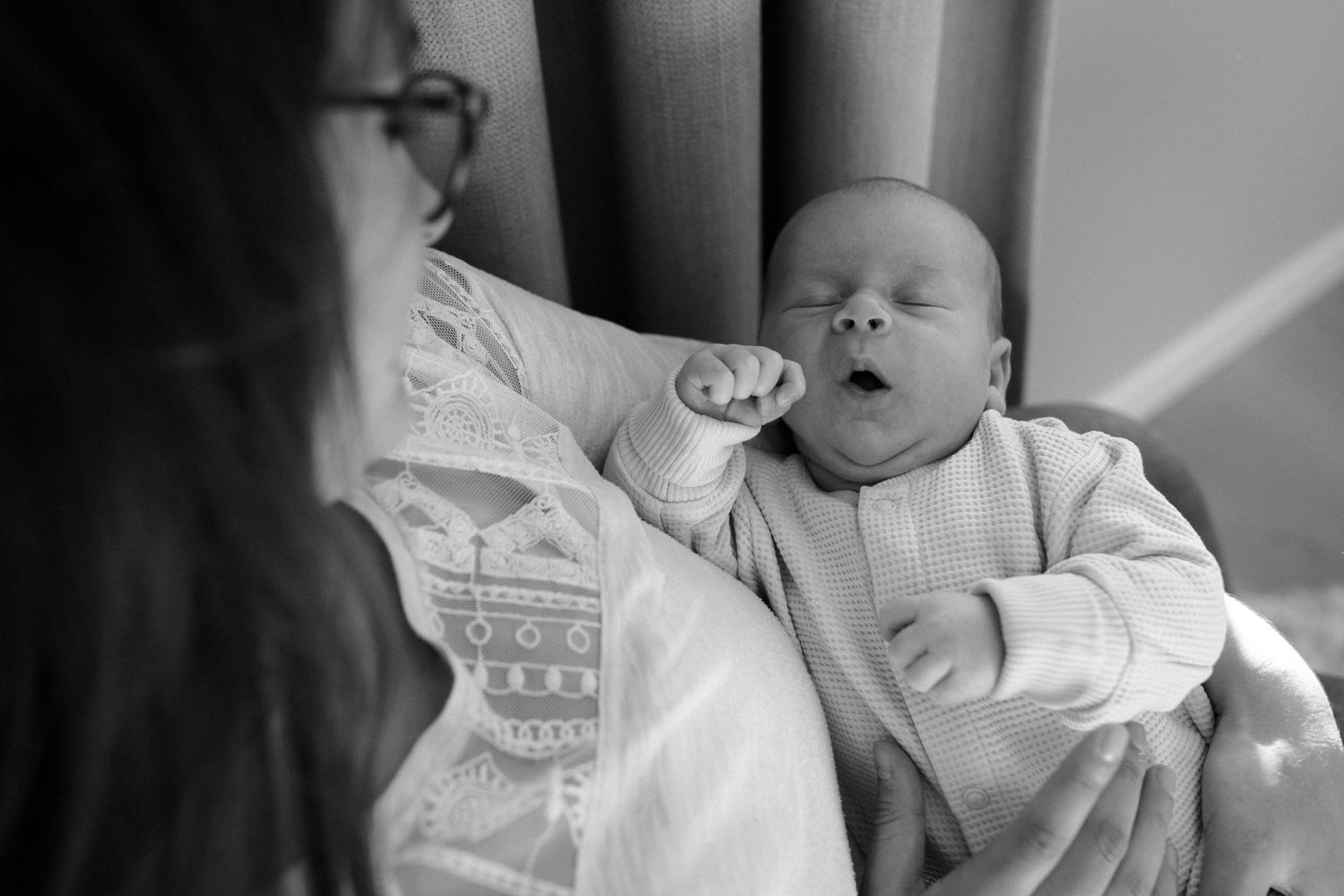 Black and white image of sleeping infant with pacifier.