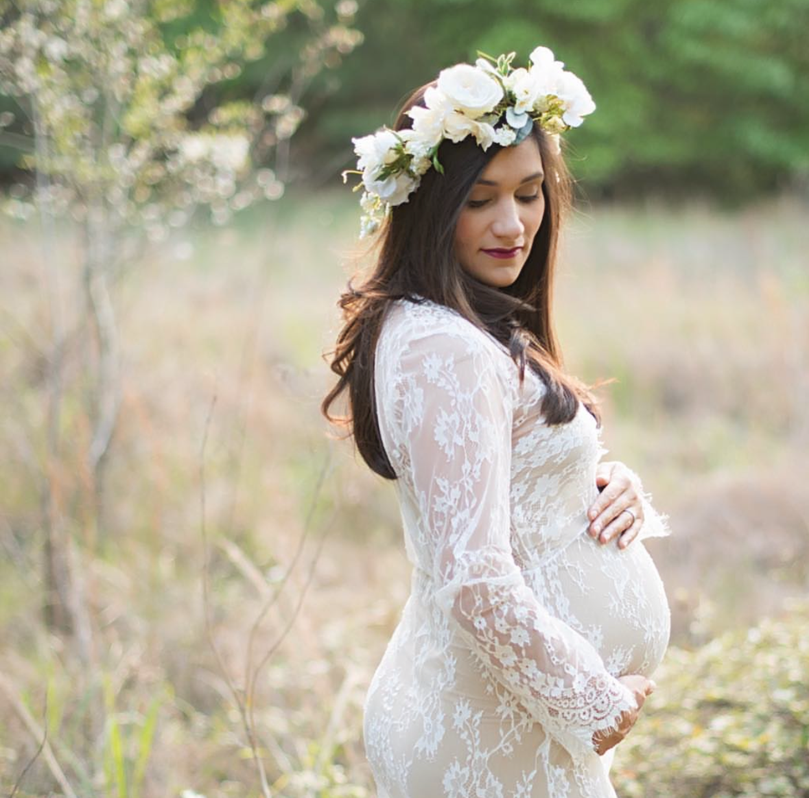 Maternity photographer in Cypress TX capturing golden hour portraits of expecting mother in flowing dress