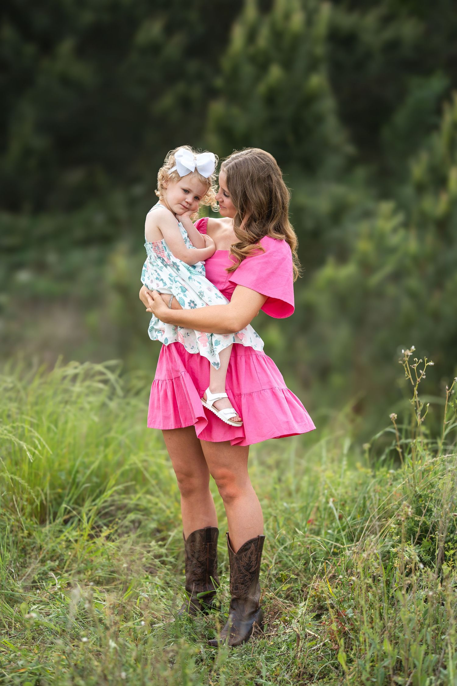 Sisters in nature captured during golden hour with natural light.