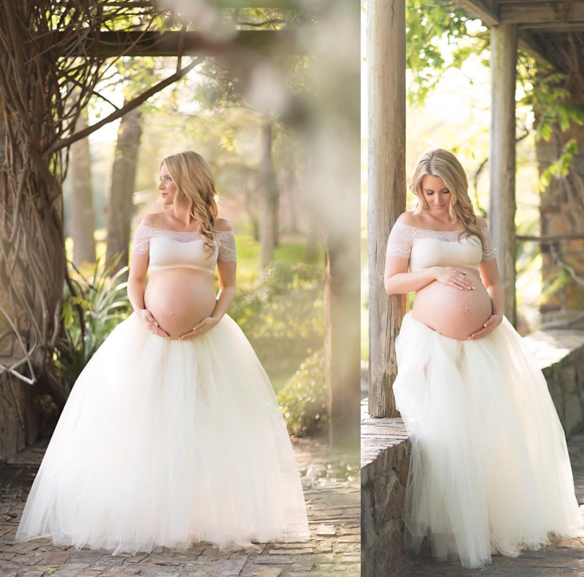 Pregnant woman in cream flowing dress at sunset holding belly – natural light maternity session by Kayleigh Kannady Photography