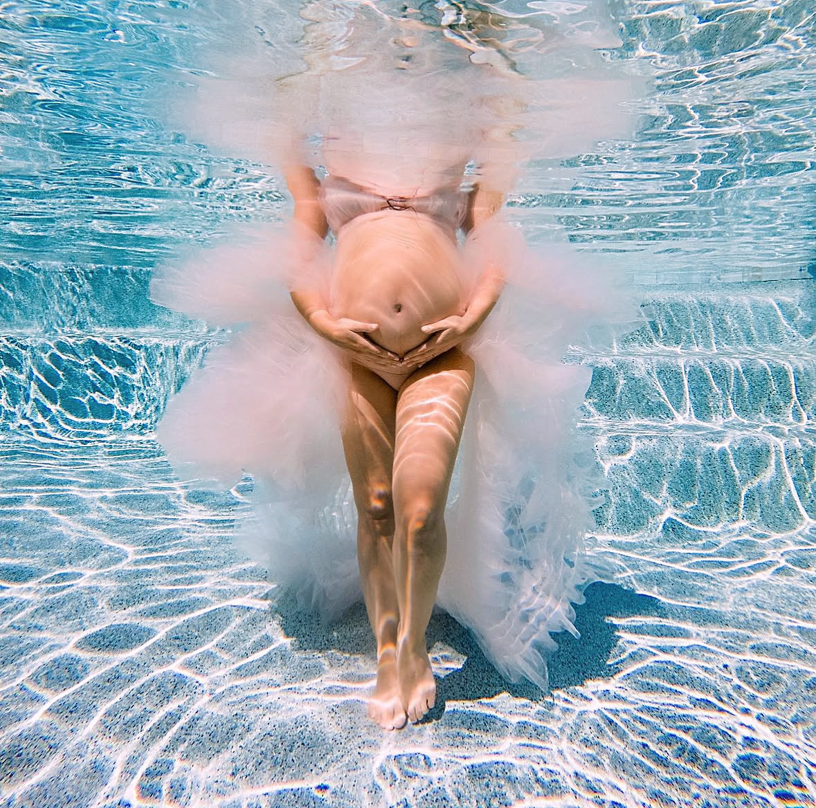underwater maternity portrait with flowing gown in the water in tomball texas